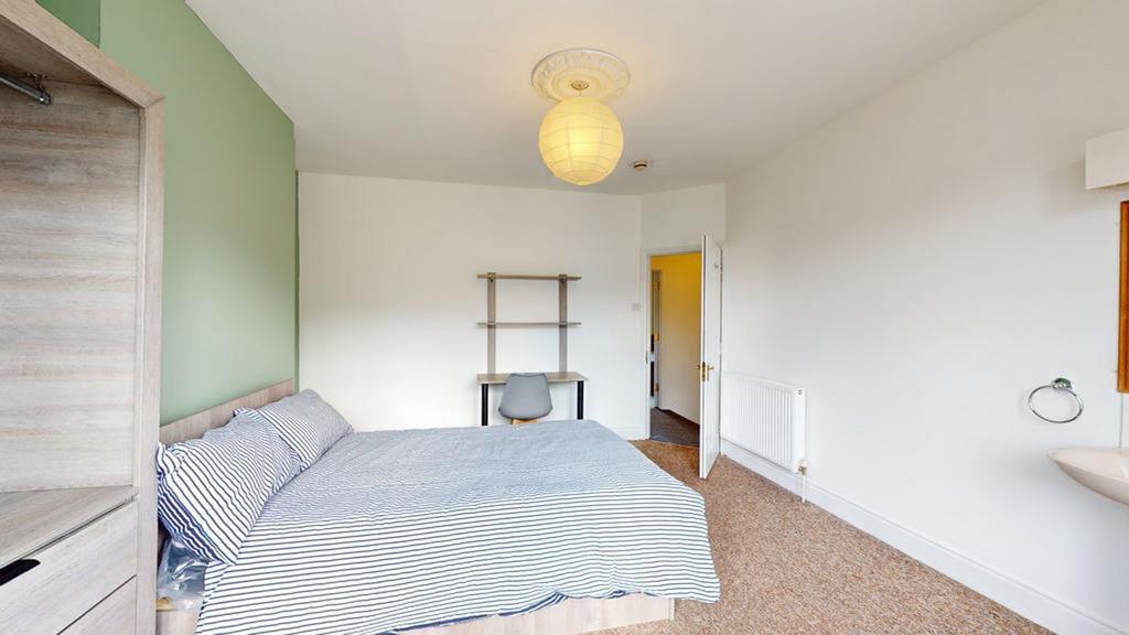 A bright and inviting double bedroom featuring ...