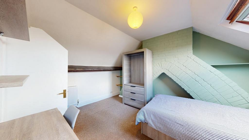 A spacious and well-lit double bedroom featurin...