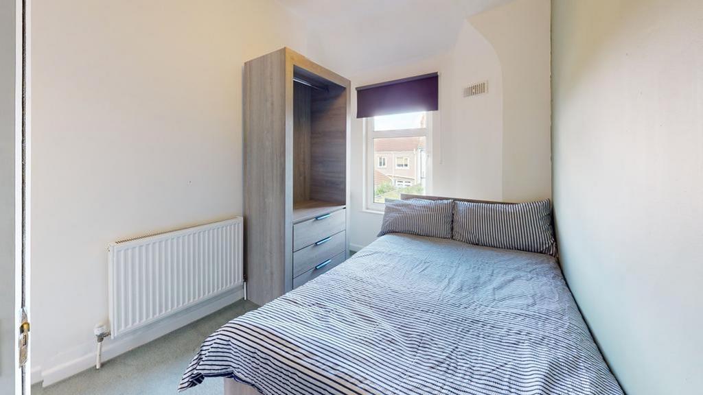 A bright and tidy double bedroom featuring a co...