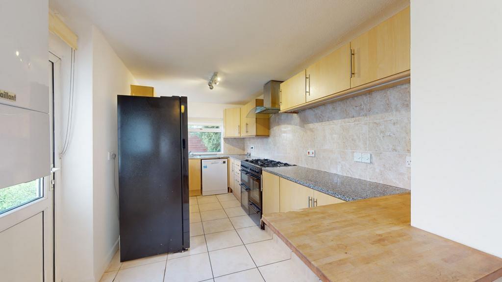 A spacious and well-maintained kitchen featurin...