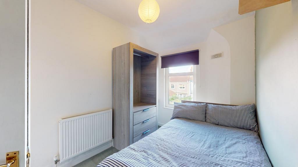 A cozy and neatly arranged double bedroom with ...
