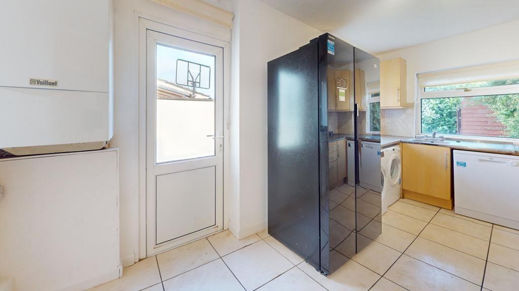 A spacious and tidy kitchen area with ample sto...