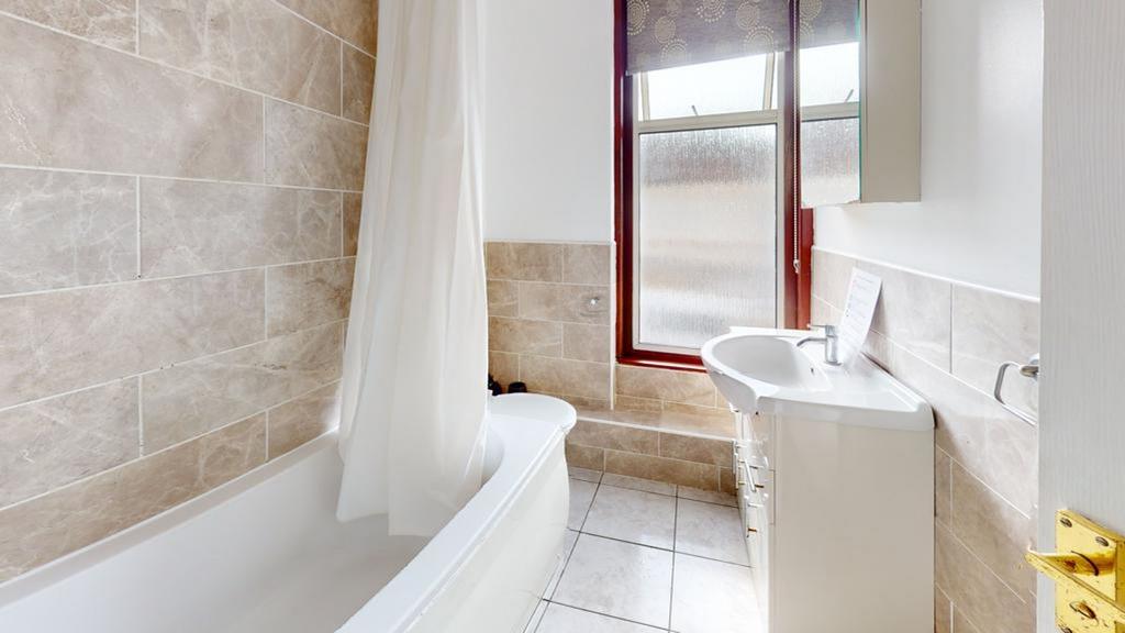 A modern and clean bathroom featuring a bath an...