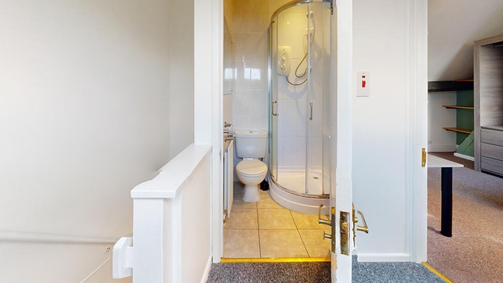 A clean and modern bathroom featuring a shower,...