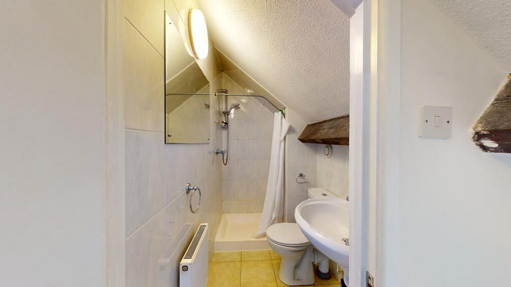 A clean and functional bathroom with ample natu...