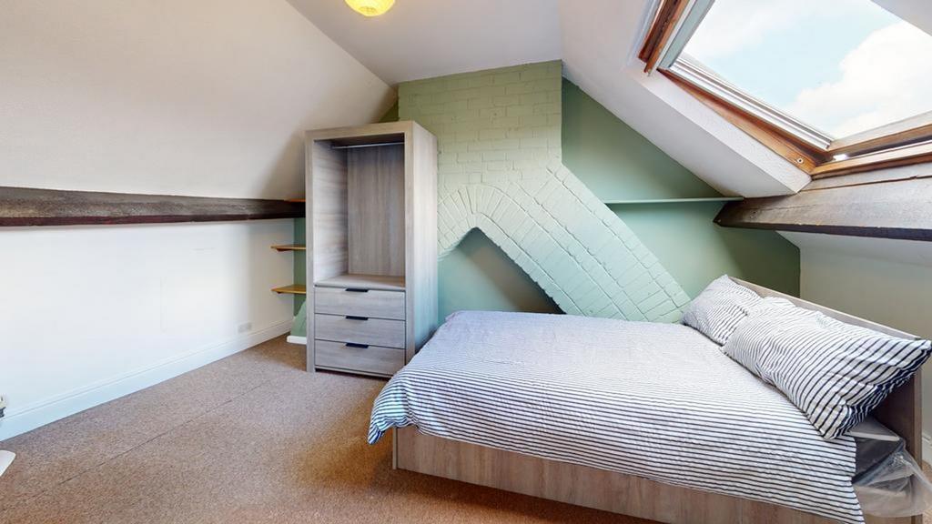 A bright and inviting double bedroom featuring ...