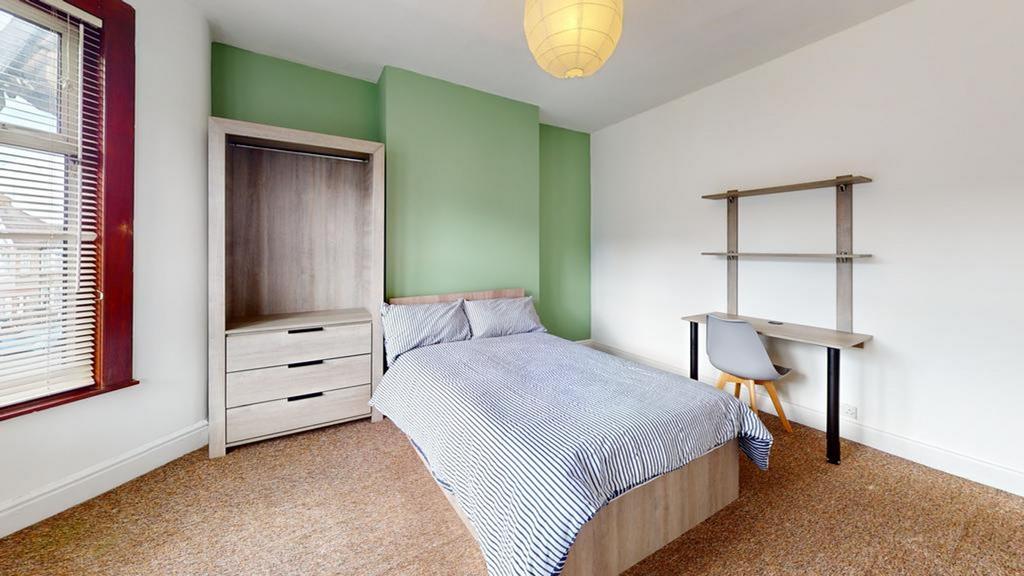 A bright and tidy double bedroom with modern fu...