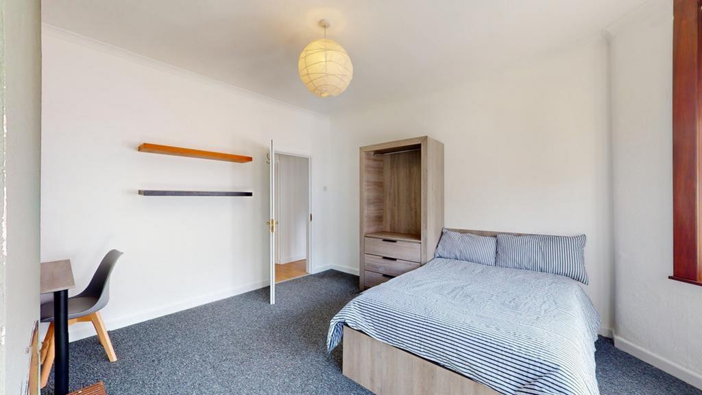 A spacious and inviting double bedroom featurin...