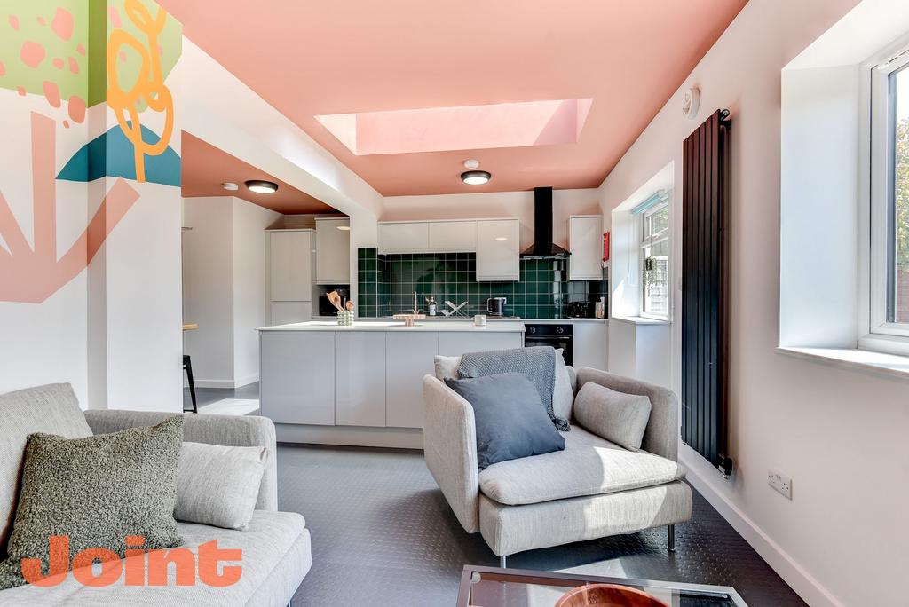 A modern kitchen featuring sleek cabinetry and ...