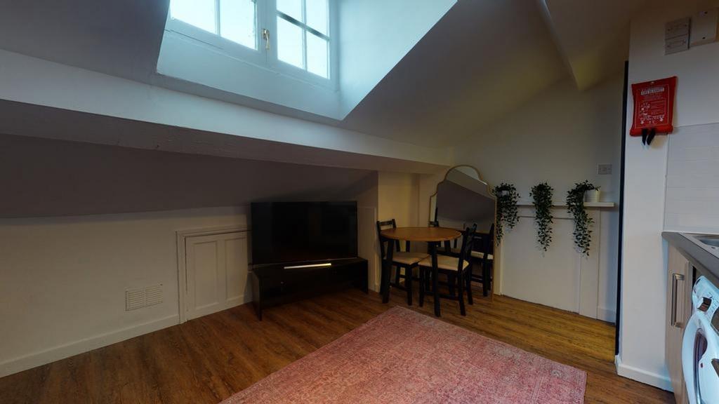 A cozy and inviting living room featuring a din...