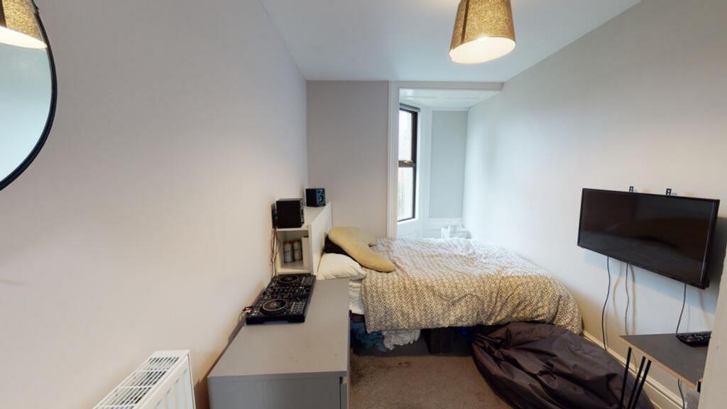 This inviting double bedroom features a comfort...