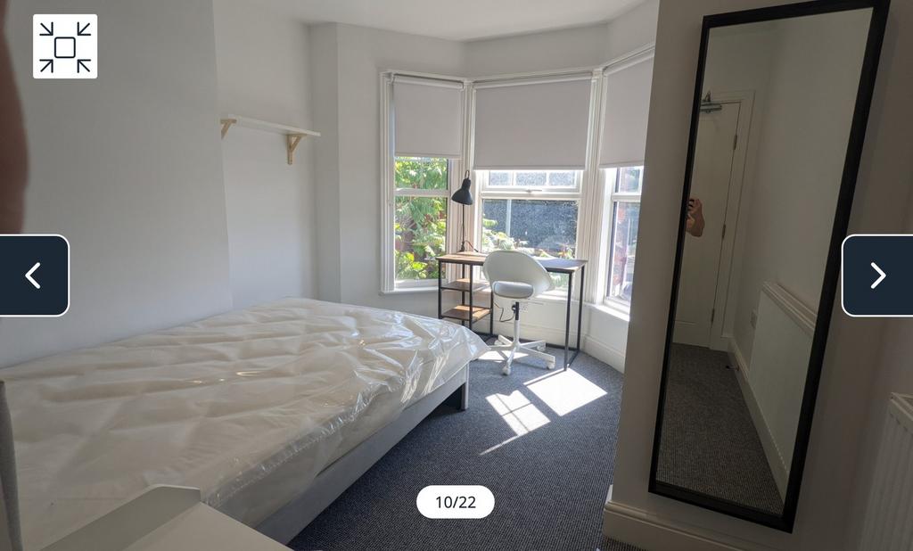 A bright and spacious double bedroom featuring ...