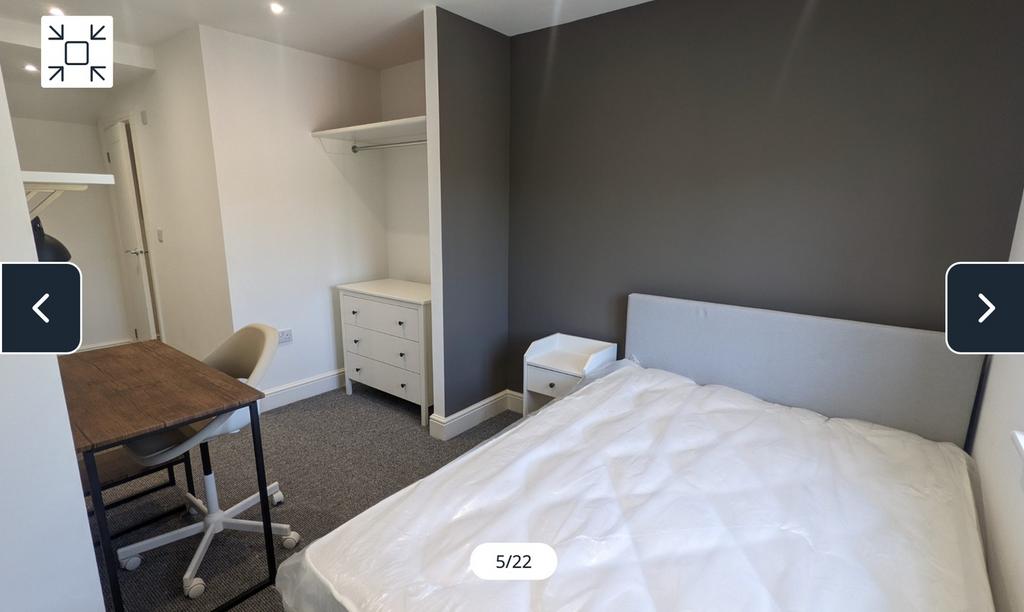 A spacious and well-lit double bedroom featurin...