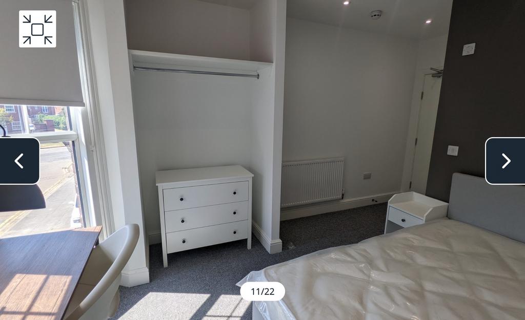 A bright and spacious double bedroom with moder...