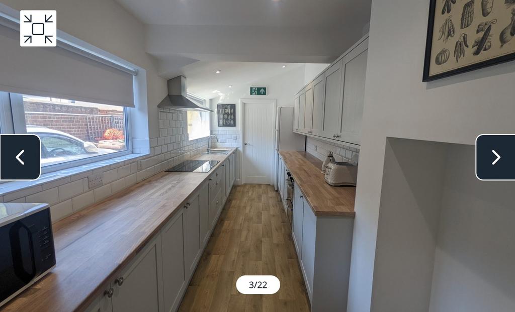 A spacious and modern kitchen featuring ample c...