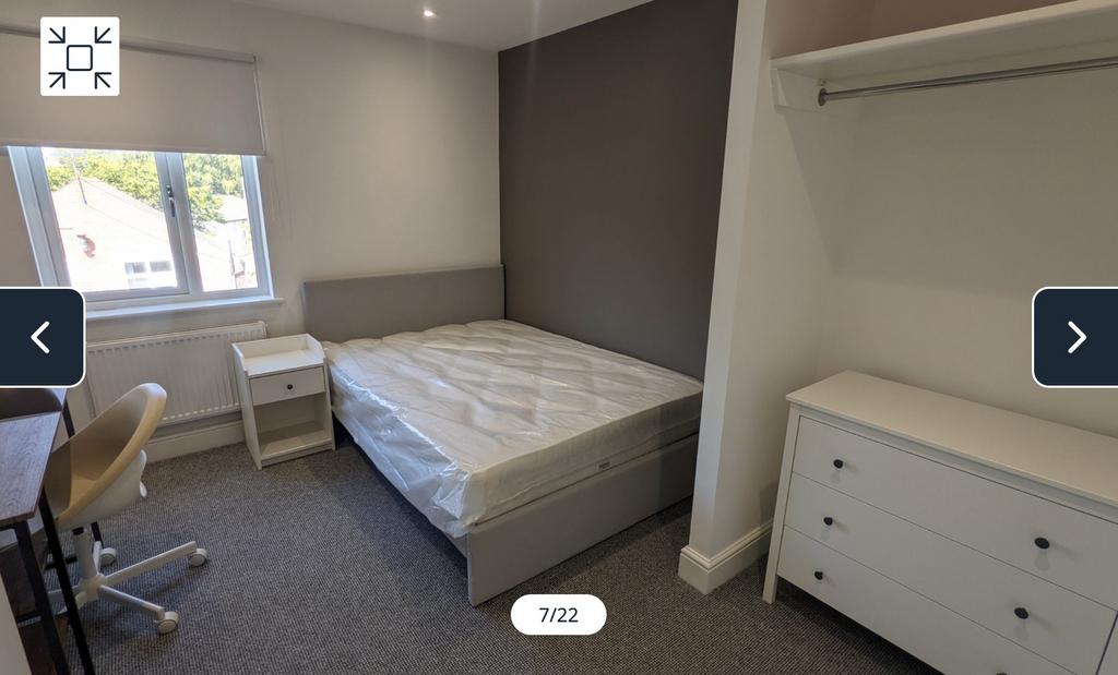 A spacious and well-lit double bedroom featurin...