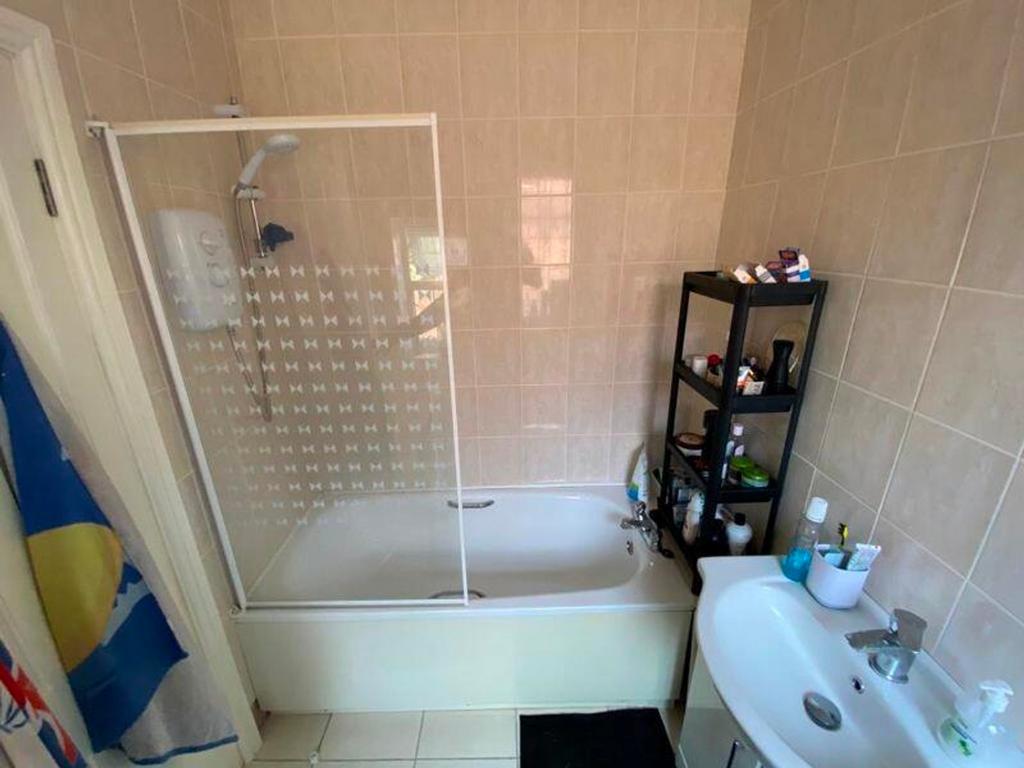 A well-maintained bathroom featuring a bath and...