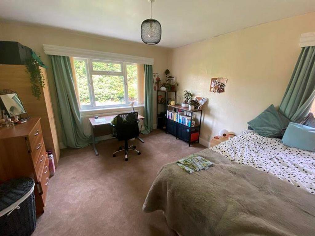 A bright and spacious double bedroom with ample...