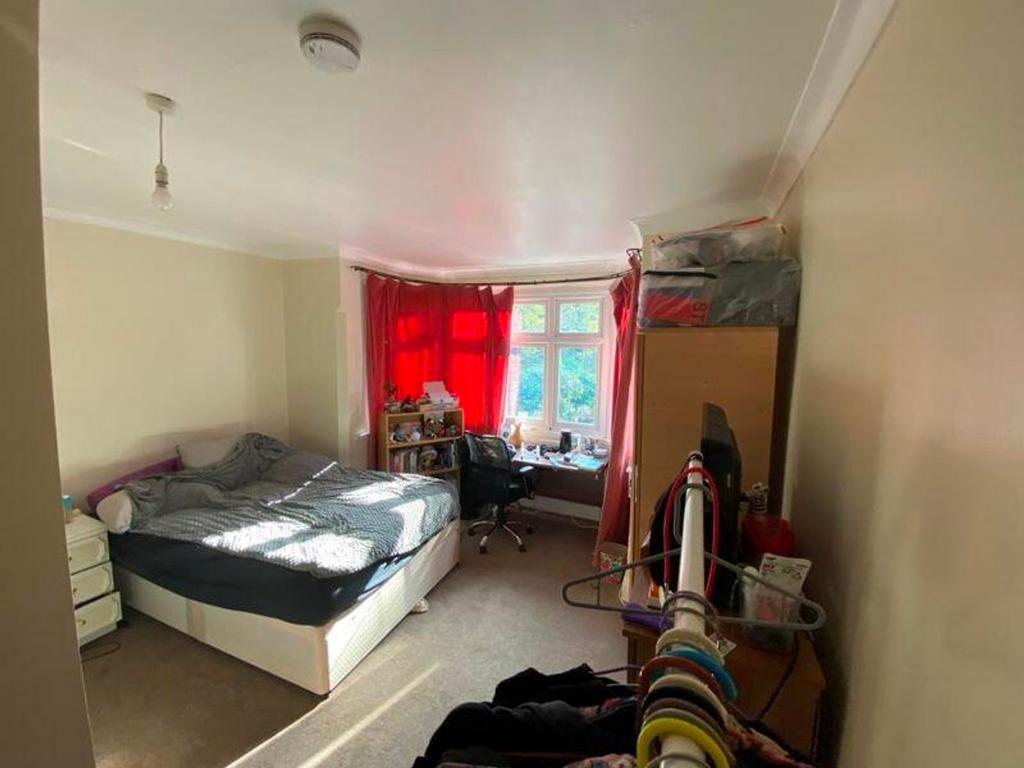 A bright and inviting double bedroom with ample...