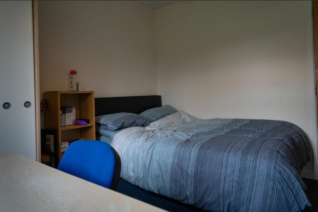 A cozy double bedroom featuring a comfortable d...