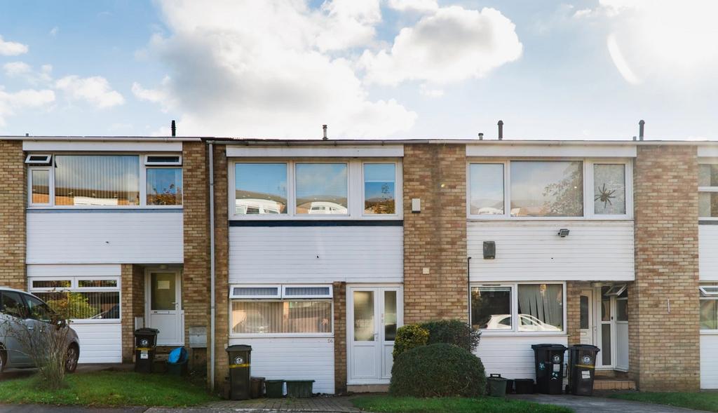 A well-maintained terraced house featuring whit...