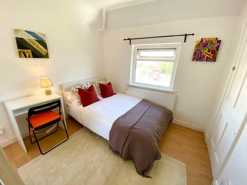 Bright and cozy double bedroom featuring a comf...