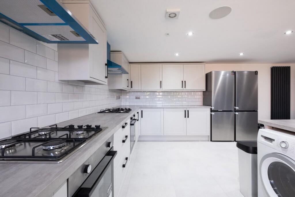 A modern kitchen featuring sleek cabinetry, hig...