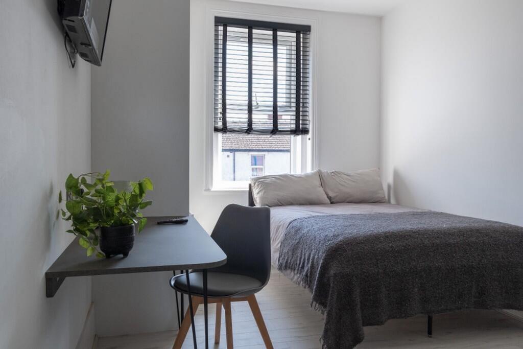 This cozy double bedroom features a comfortable...