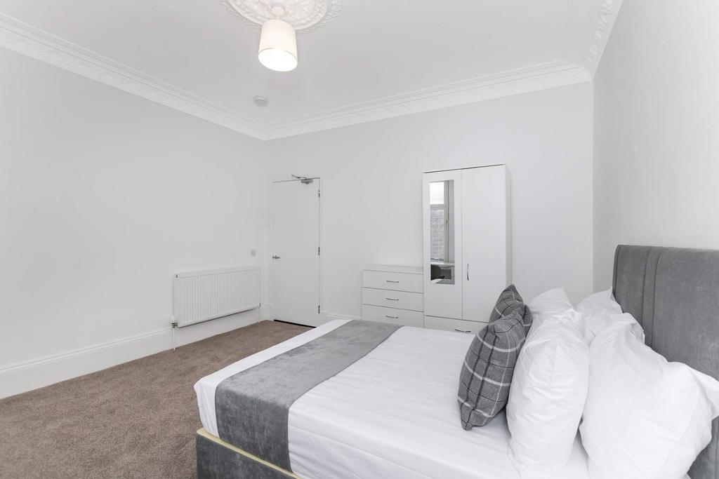 A spacious, well-maintained master bedroom feat...