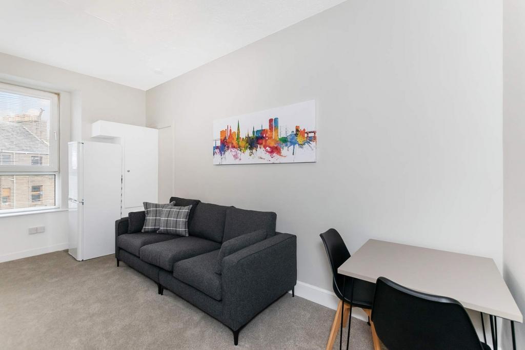 A bright living room featuring a comfortable da...