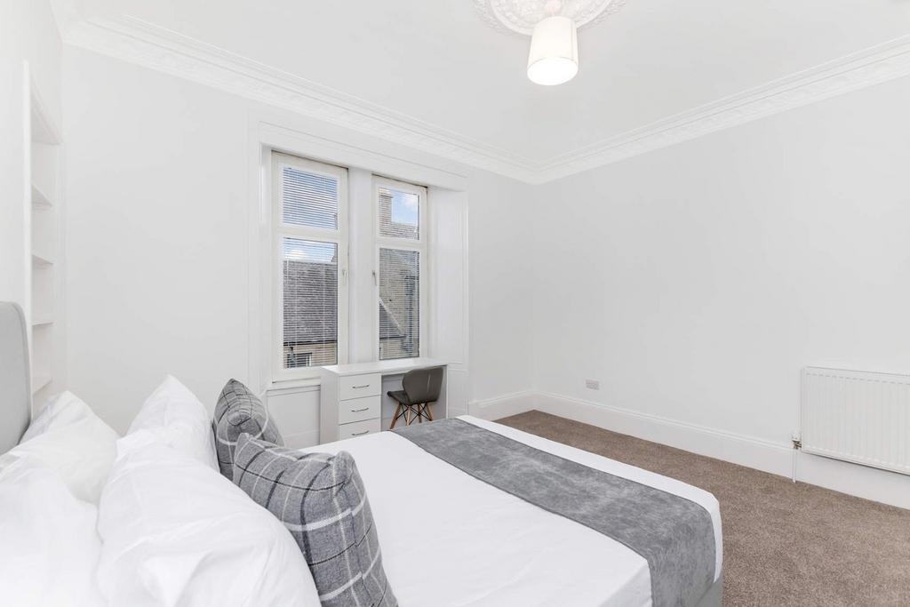 Bright and airy double bedroom featuring a comf...