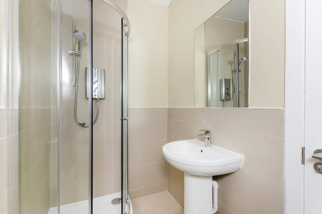 Bright and clean bathroom featuring a modern gl...