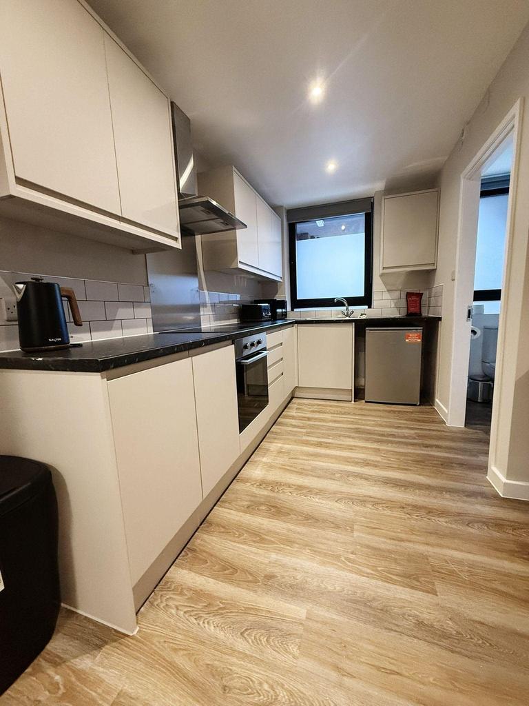 A modern and tidy kitchenette featuring sleek c...