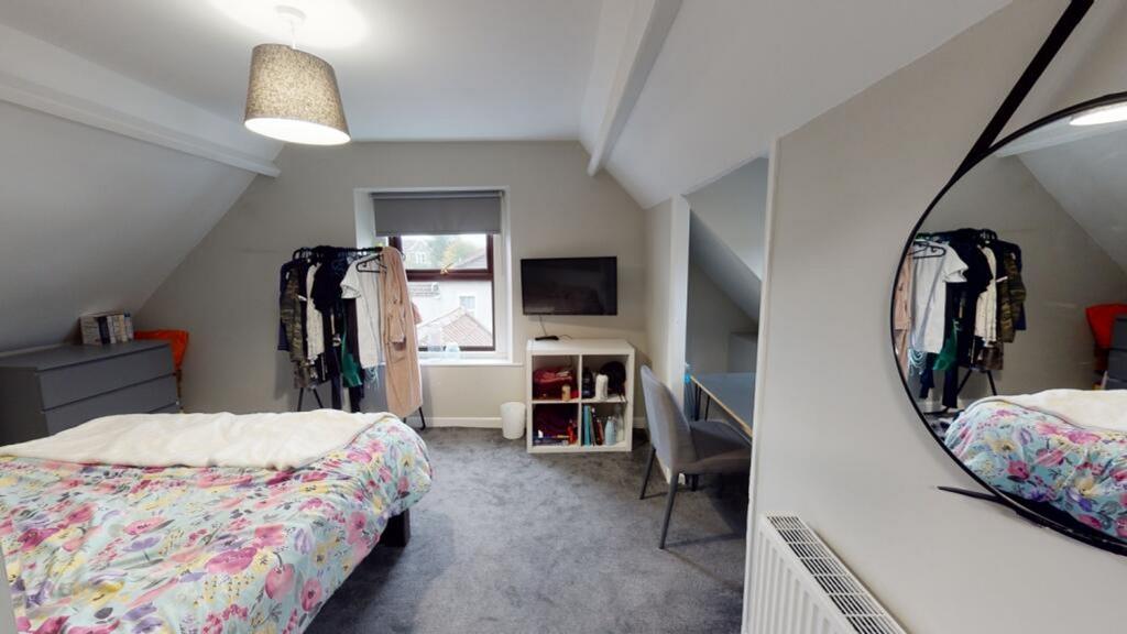 A cozy double bedroom featuring a vibrant flora...