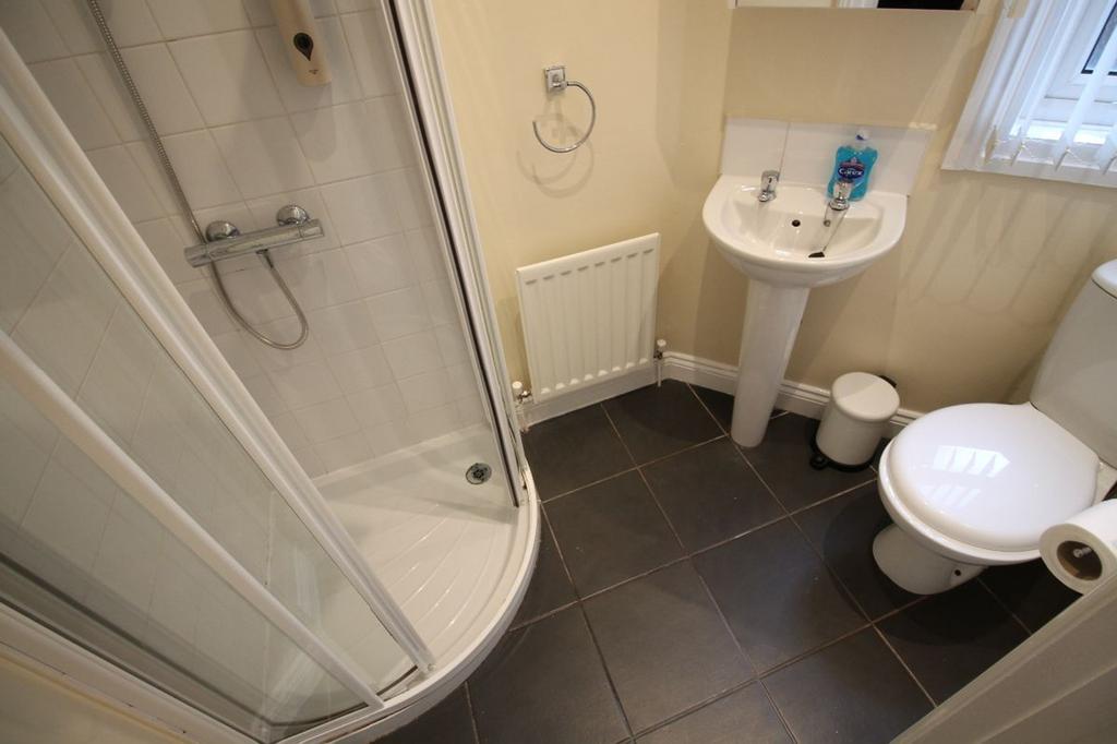 A modern bathroom featuring a stylish shower, s...