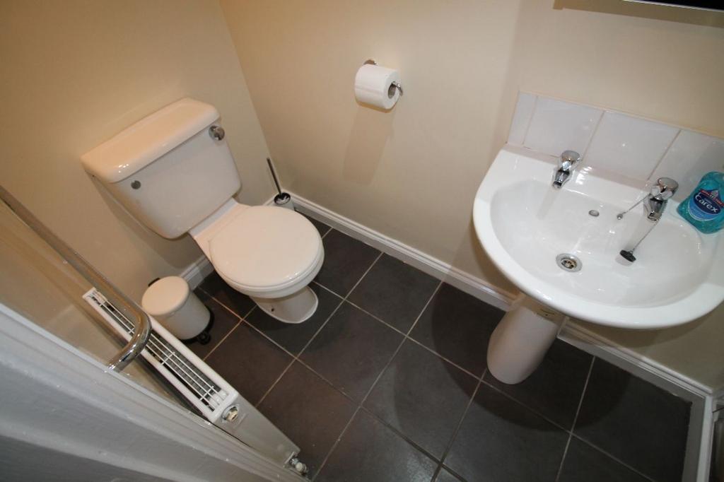 A tidy and well-maintained single toilet featur...