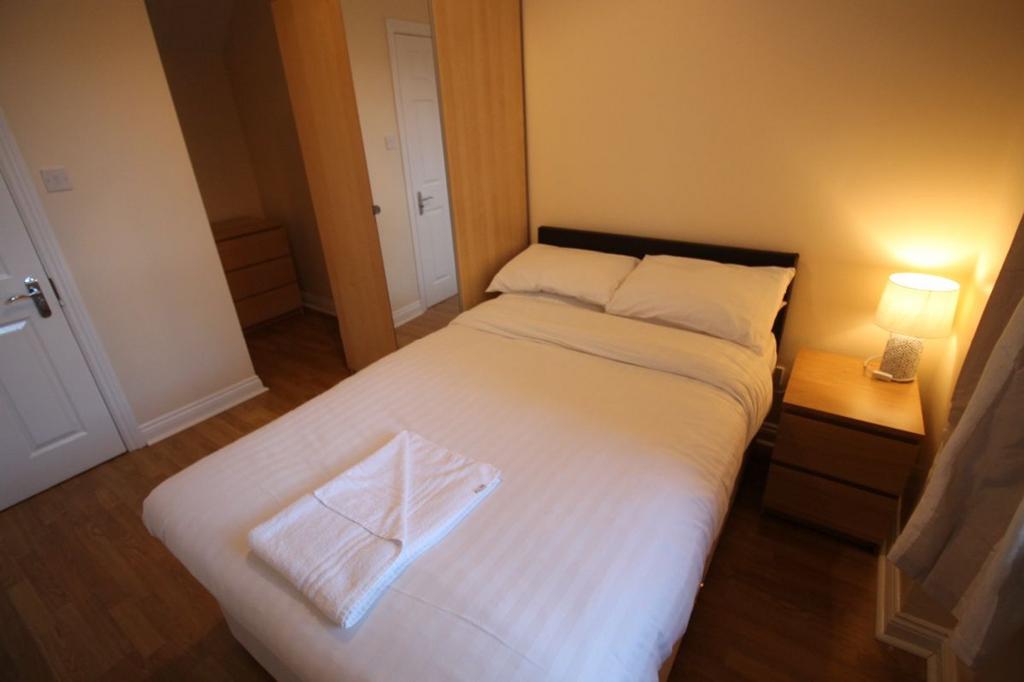 Cozy double bedroom featuring warm, inviting to...