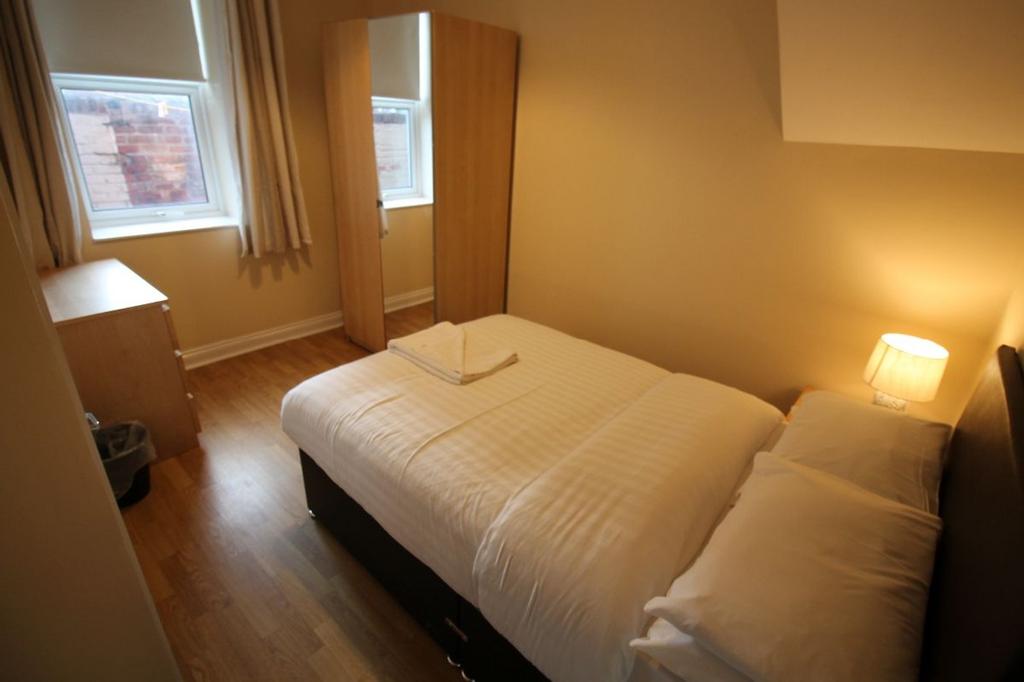Cozy double bedroom featuring ample natural lig...