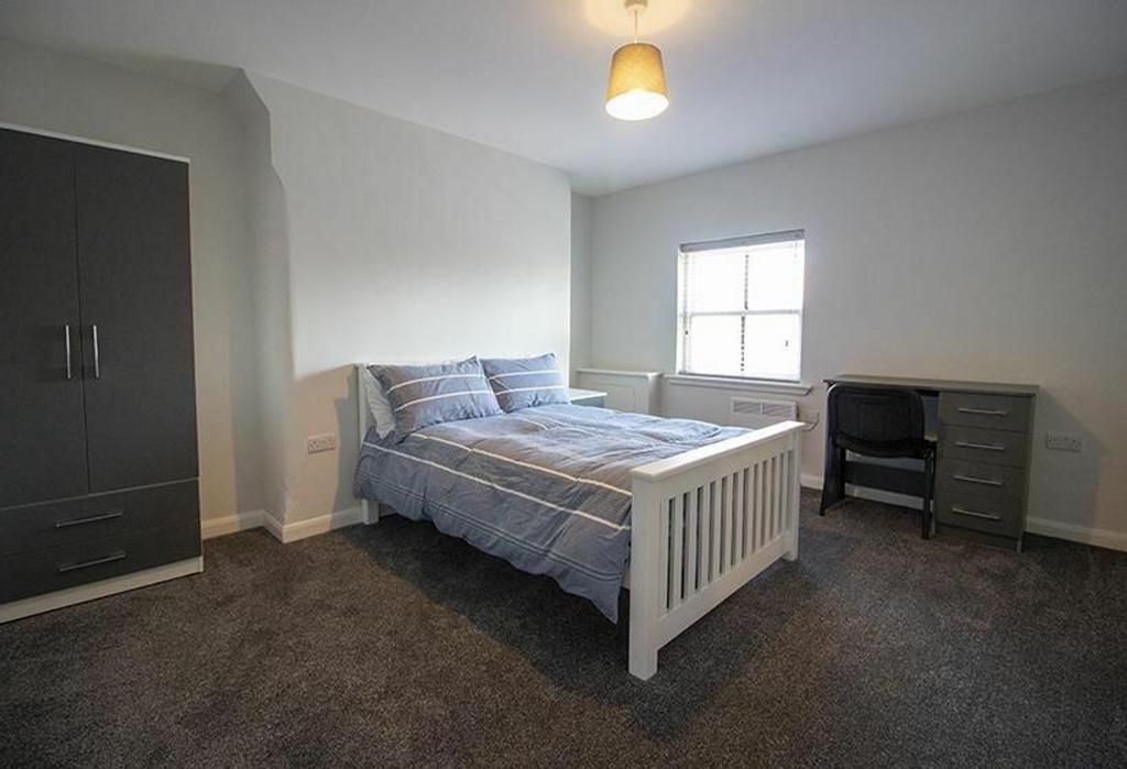 This inviting double bedroom features a spaciou...