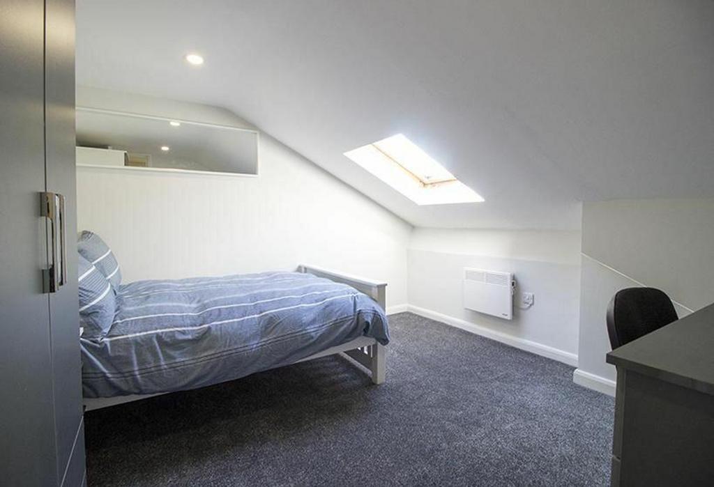 This inviting double bedroom features a cozy la...