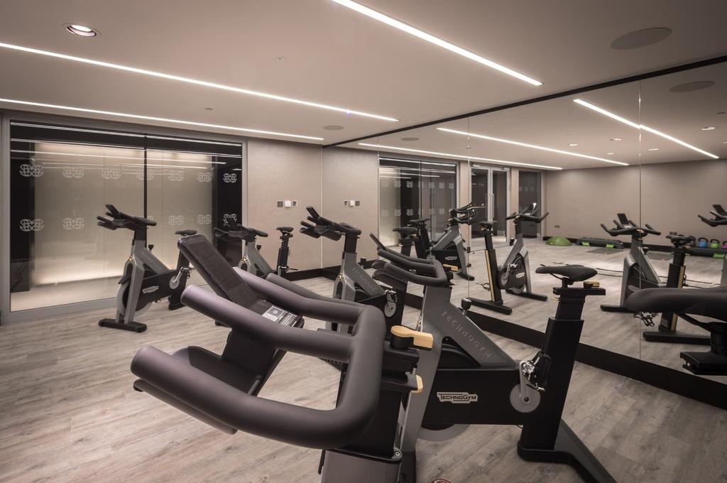 A sleek, modern gym equipped with multiple stat...