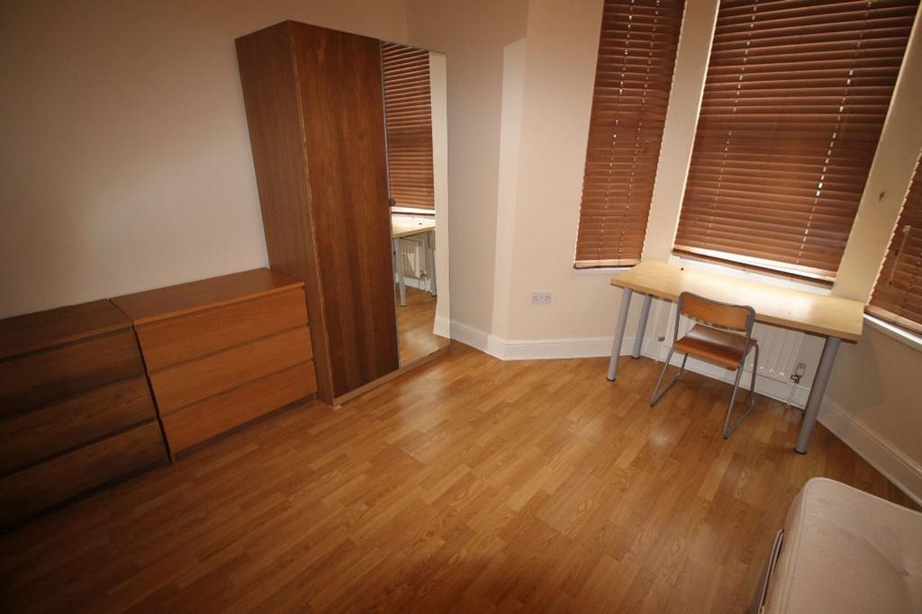 A cozy double bedroom featuring stylish wooden ...