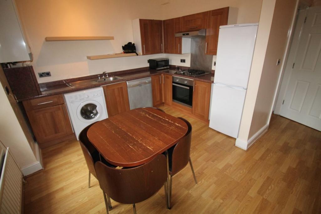 A well-equipped kitchen featuring modern applia...