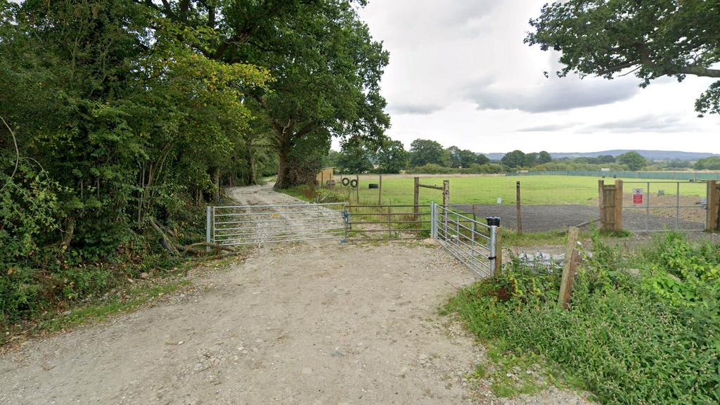 Gated access set-back from Lydens Lane.