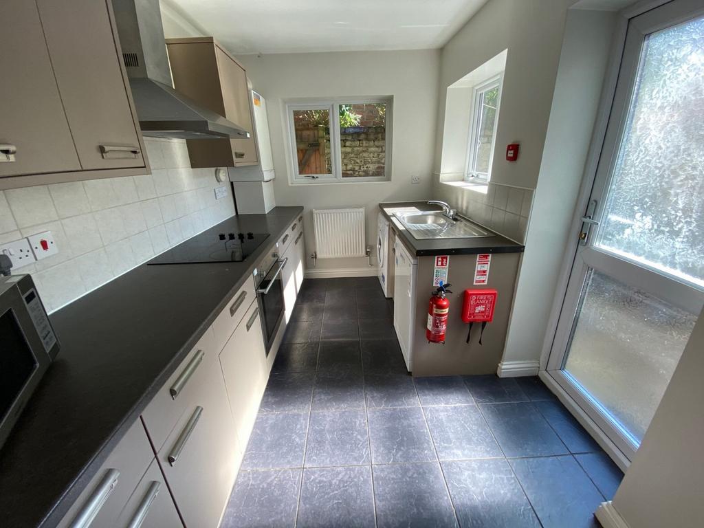 A modern and well-lit kitchenette with ample co...