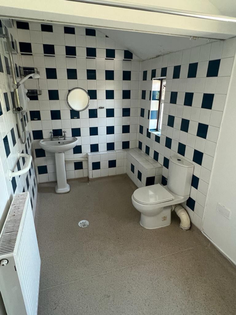 A modern bathroom featuring stylish tiled walls...