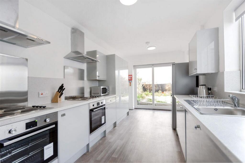 Modern and spacious kitchen featuring sleek cab...