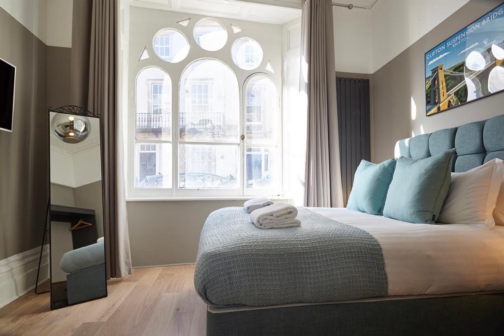 A bright and clean double bedroom featuring a c...