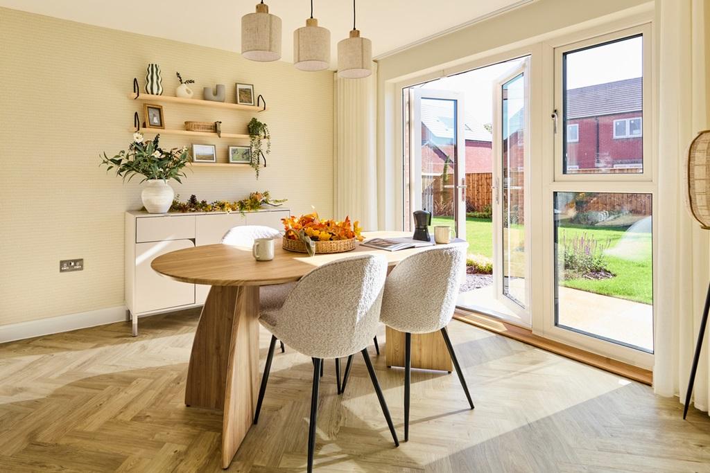 Double doors to the garden floods the dining...