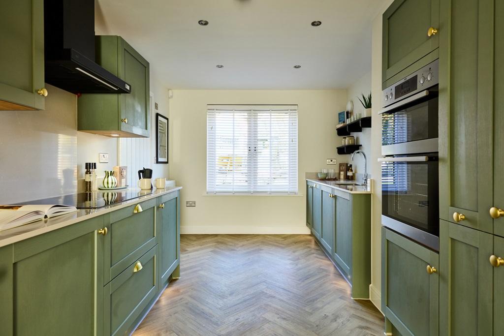 The modern kitchen leads through to the dining...